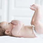 Mother changing baby diaper