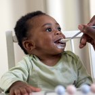 Portrait of young woman feeding her baby