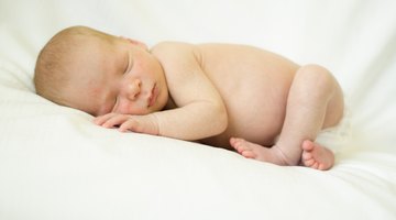 Portrait of young woman feeding her baby
