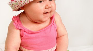 Hispanic mother helping baby walk