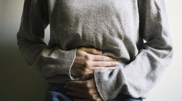 asian caucasian woman with pain in her stomcah