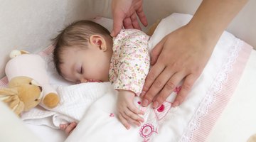 Mother reading bedtime story to daughter