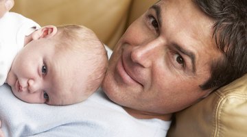 Hispanic mother hugging baby