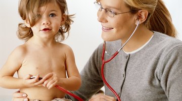 Closeup of caring mother holding head on sick daughter forehead