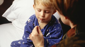 Mother taking sons (3-4) temperature in bedroom, close-up