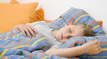 Hands of mother caressing her baby girl sleeping