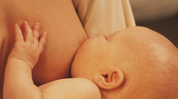 Manual breast pump and milk at background