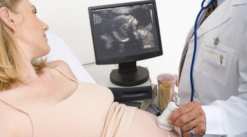 Pregnant Woman And Partner Having 4D Ultrasound Scan
