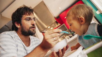 Mother Spoon-Feeding Her Infant