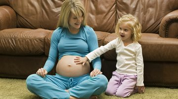Male hands on pregnant belly