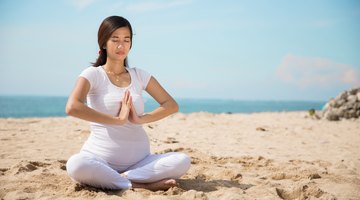 Cropped pregnant woman touching belly