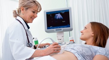 Pregnant Woman And Partner Having 4D Ultrasound Scan
