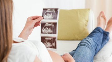 Side view of mother raising baby in air