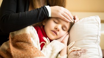 Girl (18-24 months) and doctor smiling