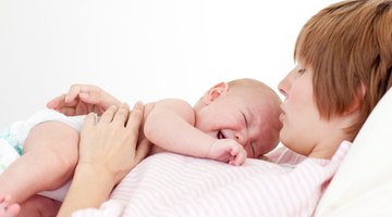Mother breast feeding baby girl
