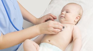 Small baby with mother on bed