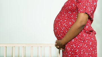 Pregnant woman looking in refrigerator