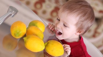 Portrait of young woman feeding her baby