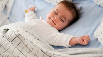 portrait of a baby boy in a crib