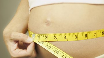 Pregnant woman having bowl of salad