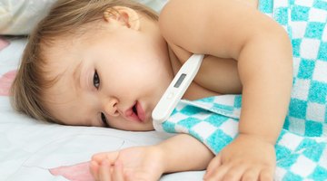 Small baby with mother on bed