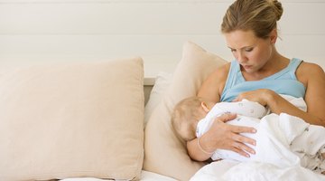 Positive mother feeding her adorable son in the kitchen