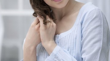 Attractive pregnant woman holding a bowl of salad while standing