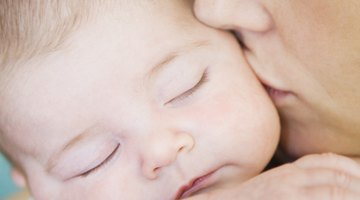 Cute baby boy in a white crib