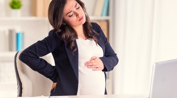 Pregnant Asian couple hugging