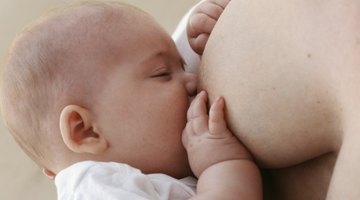 Manual breast pump and milk at background