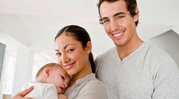 Pregnant woman eating strawberries on sofa