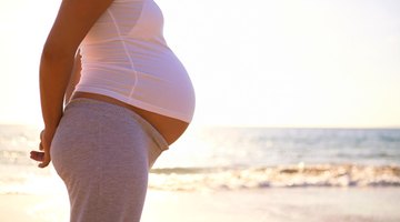 Husband and pregnant wife in hospital with doctor