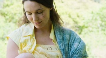 Mother breast feeding baby girl
